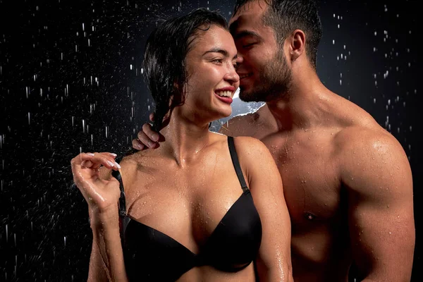 Сексуальные кавказцы: мужчина и женщина позируют перед камерой на черном фоне. — стоковое фото