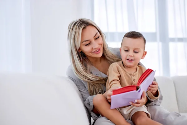 Adorável família jovem mãe babá segurar ler livro relaxar abraçar bonito menino — Fotografia de Stock