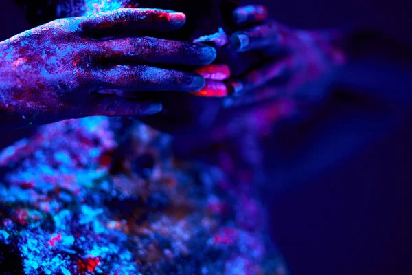 Female Native American with neon makeup, made of fluorescent paint in ultraviolet light. — Stock Photo, Image