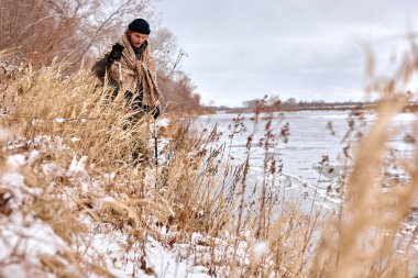 young man traveler. Happy hiker, climber in winter nature, forest, mountians. caucasian man hiker, relaxing in winter forest. active healthy lifestyle, bushcraft, hobby, expedition concept