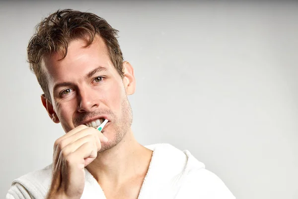 Sleepy Tired Caucasian American Guy Brushing Tooth Morning Isolated Gray — Stockfoto