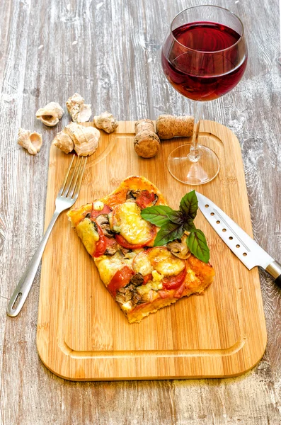 Slice of pizza is on a wooden board — Stock Photo, Image