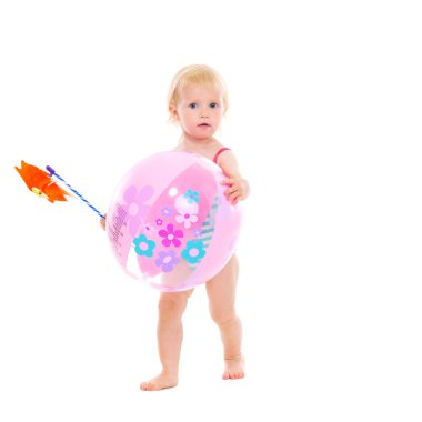 Baby girl in swimsuit holding pinwheel and beach ball clipart