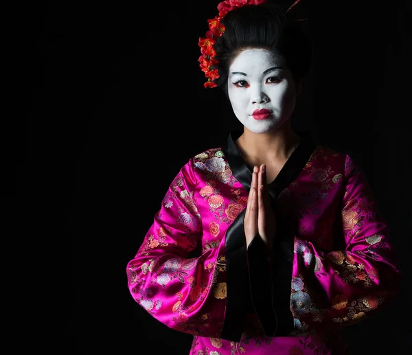 Portrait of geisha with hands together respect gesture isolated — Stock Photo, Image