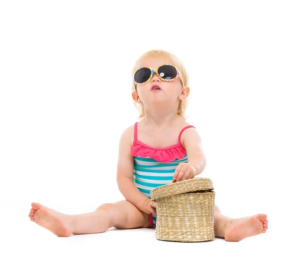 Baby in swimsuit and sunglasses looking up — Stock Photo, Image