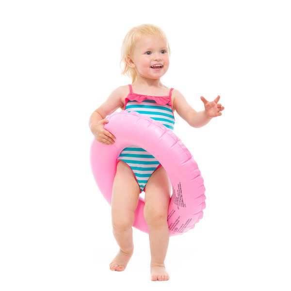 Happy baby in swimsuit with inflatable ring