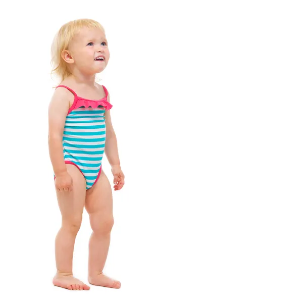 Bebé niña en traje de baño en busca de espacio de copia —  Fotos de Stock