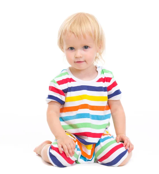 Lovely baby in swimsuit sitting on floor — Stock Photo, Image