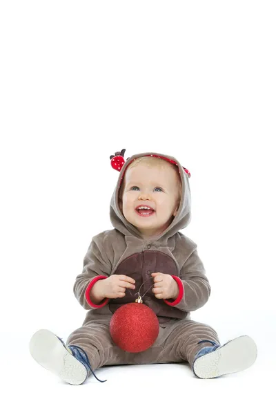 Smiling baby with Christmas ball looking up on copy space — Stock Photo, Image