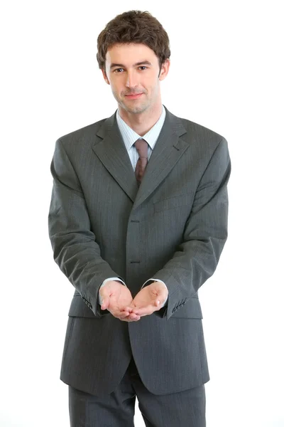 Businessman showing something on open palms — Stock Photo, Image