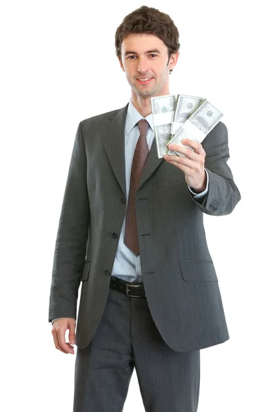 Smiling businessman showing packs of dollars — Stock Photo, Image