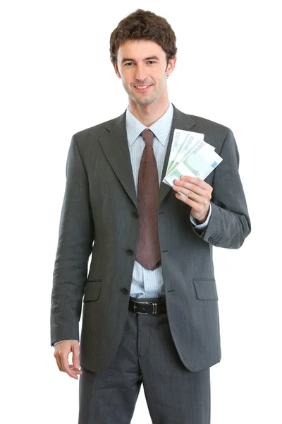 Empresário sorridente mostrando pacotes de euros — Fotografia de Stock