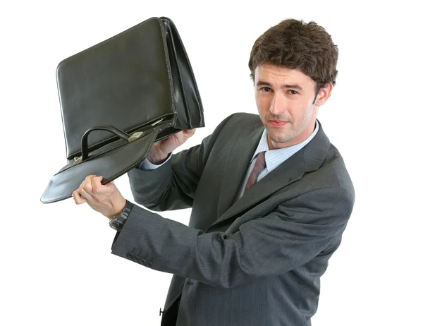 Concerned businessman shakes out something from suitcase — Stock Photo, Image