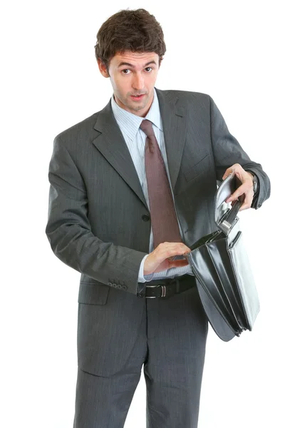 Concerned businessman looking into suitcase — Stock Photo, Image