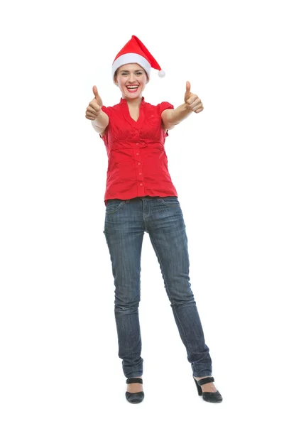 Full length portrait of smiling young woman in Christmas hat sho Stock Image