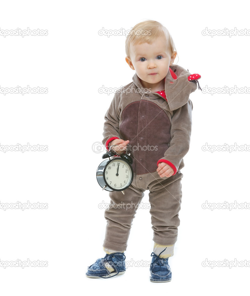 Baby in Santa's deer costume holding alarm clock