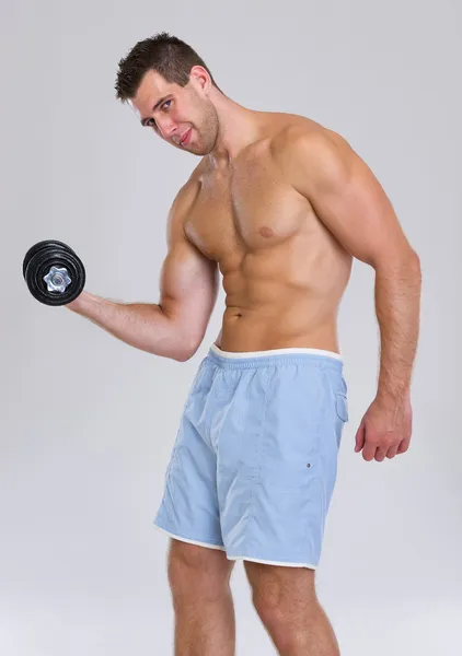 Strong athletic man workout biceps with dumbbell — Stock Photo, Image