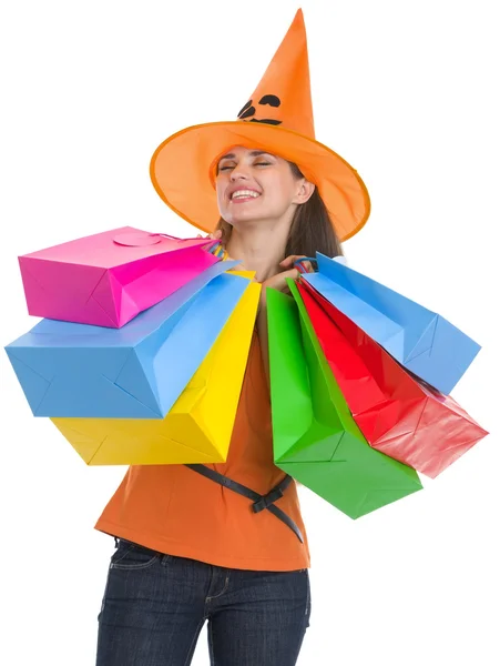 Happy young woman in Halloween hat with shopping bags — Stock Photo, Image