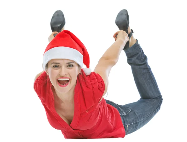 Cheerful young woman with Christmas hat laying on floor — Stock Photo, Image