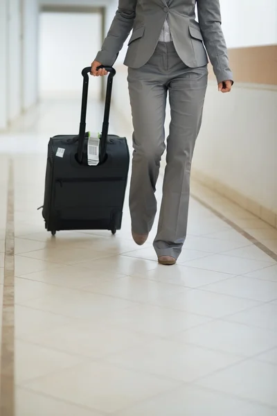 Closeup on business woman walking with wheel bag — Stock Photo, Image