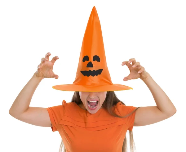 Woman in Halloween hat over eyes making scaring pose Royalty Free Stock Photos