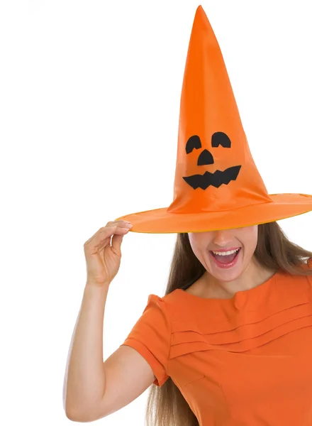 Woman pulling Halloween hat over eyes Stock Image