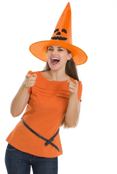 Happy young woman in Halloween hat pointing on you Stock Picture