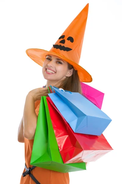 Portrait of happy young woman in Halloween hat with shopping bag Stock Picture