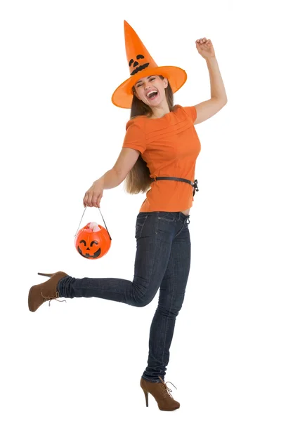 Full length portrait of happy woman holding Halloween bucket Stock Image