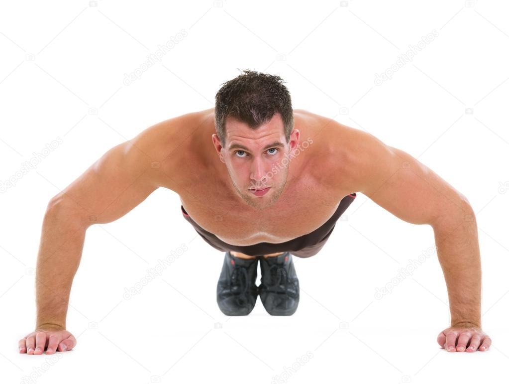 Muscular man making push up exercises