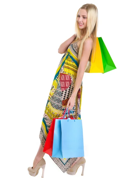 Chica feliz en vestido sosteniendo bolsas de compras —  Fotos de Stock