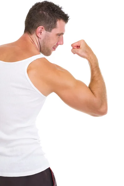 Athletic man showing strong biceps — Stock Photo, Image