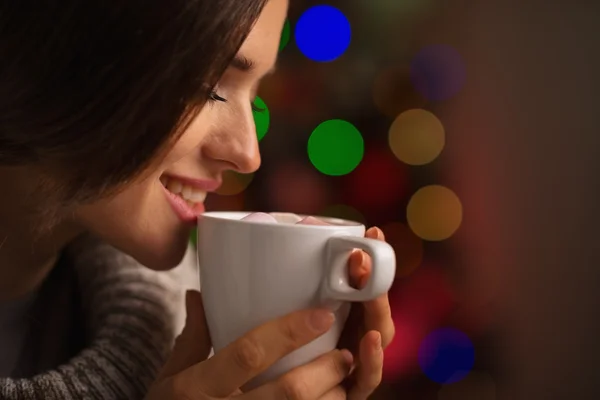 Happy young woman enjoying cup of hot beverage in front of Chris — Stock Photo, Image