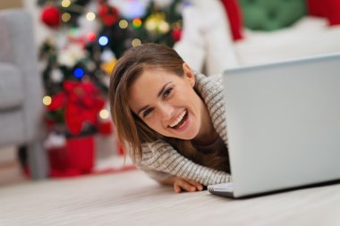 gülümseyen kadın Noel ağacı önünde laptop arıyorum