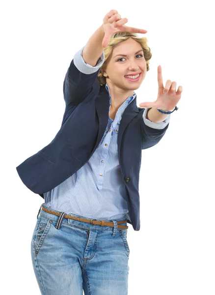 Smiling teenage girl looking through frame created with hands — Stock Photo, Image