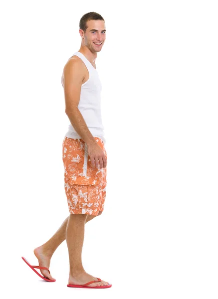 Full length portrait of happy young man going sideways — Stock Photo, Image