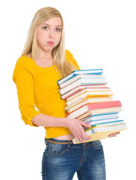 Cansada estudiante chica sosteniendo pila de libros —  Fotos de Stock