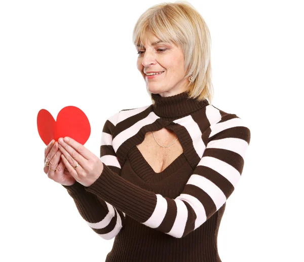 Woman reading heart shaped postcard — Stock Photo, Image