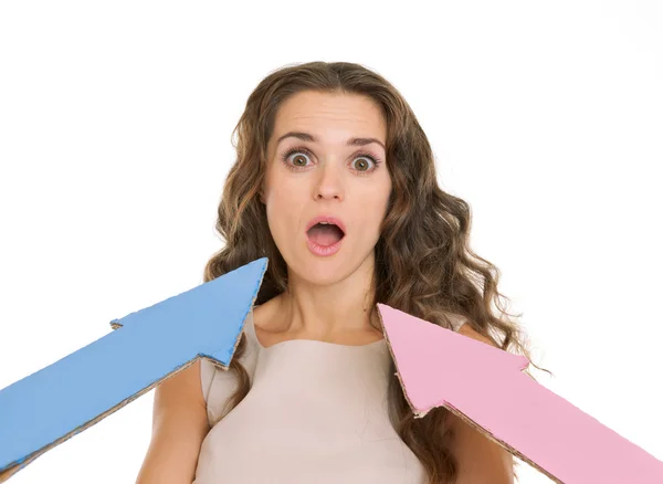 Arrows points on confused young woman — Stock Photo, Image