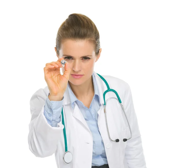 Medical doctor woman using syringe as darts — Stock Photo, Image