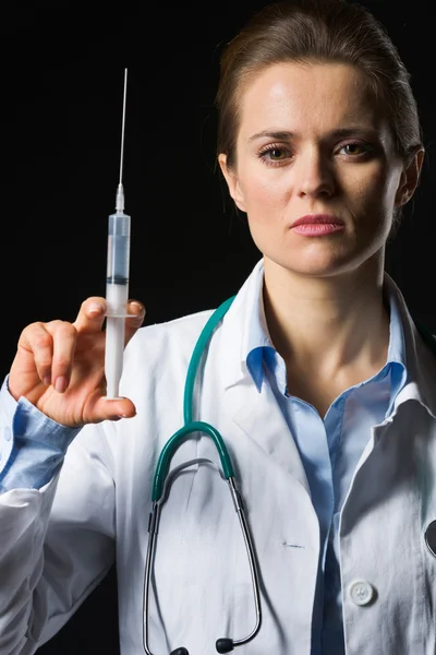 Closeup on medical doctor woman holding syringe isolated — Stock Photo, Image