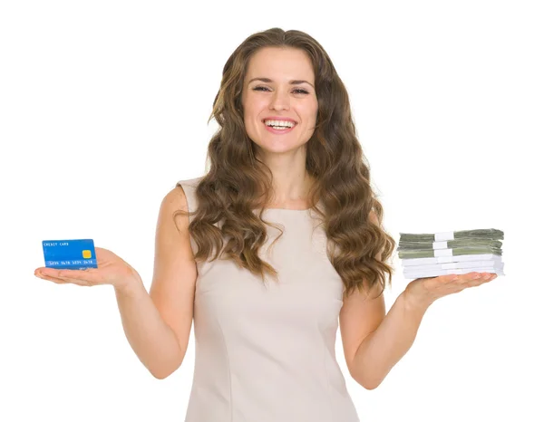 Young woman holding credit card and dollars packs — Stock Photo, Image