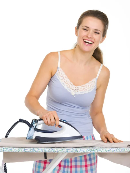 Young woman in pajamas ironing — Stock Photo, Image