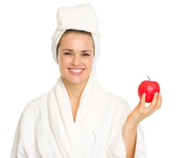 Mujer joven sonriente en albornoz con manzana —  Fotos de Stock