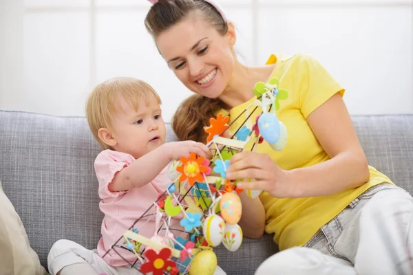 Baby playing with Easter decorations — Stock Photo, Image