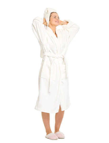 Full length portrait of woman taking off bathrobe. Rear view Stock Picture