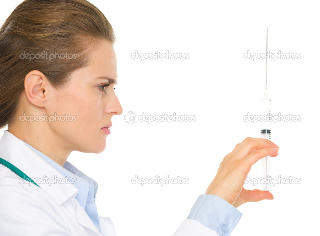 Closeup on medical doctor woman holding syringe