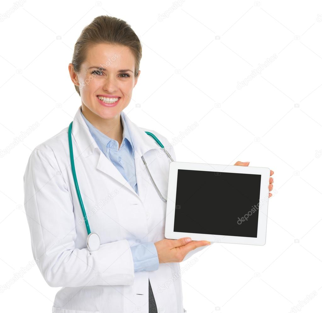 Smiling medical doctor woman showing tablet PC with blank screen