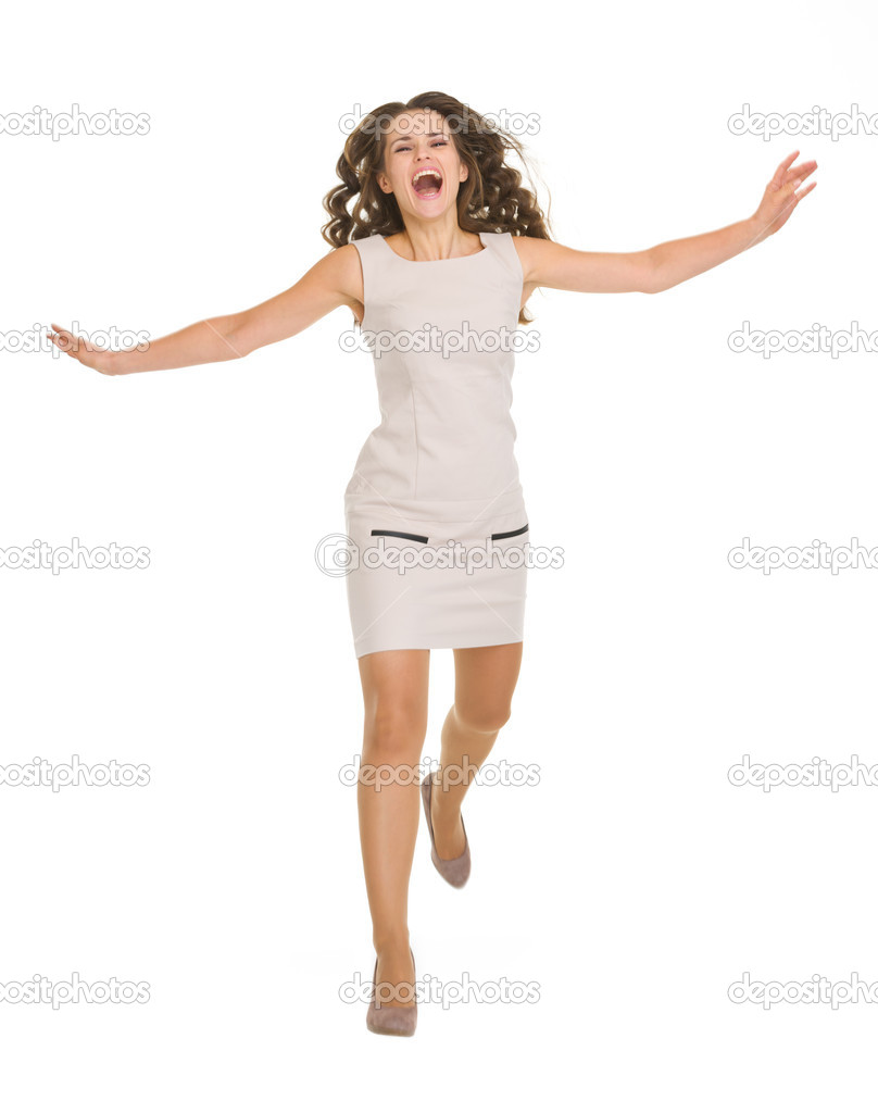 Young woman in dress jumping forward