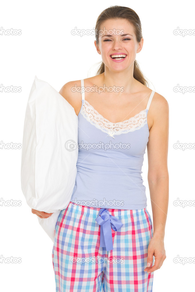 Young woman in pajamas holding pillow